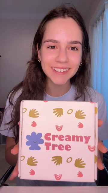 A girl smiling as she shares her Creamy Tree package
