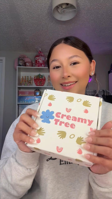 A girl smiling while she shares her Creamy Tree package