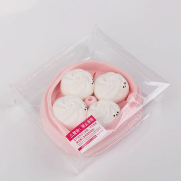 Side view of Creamy Tree Pink and White Dumplings Squishy toy with safety label