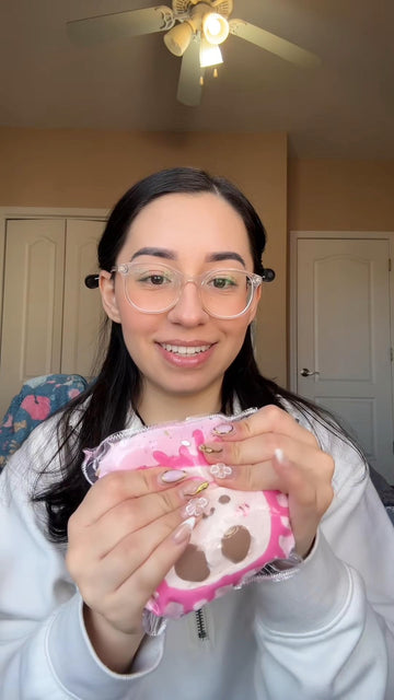 A girl with glasses sharing her Creamy Tree JC Toast Squishy