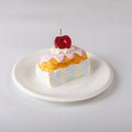 Side view of Creamy Tree Cherry Bar Cake Squishy Toy