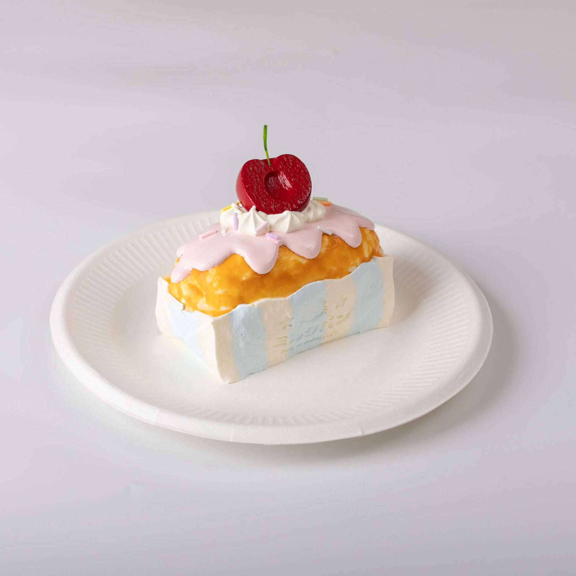 Side view of Creamy Tree Cherry Bar Cake Squishy Toy