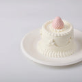 Elodie Pink Strawberry Cake Squishy Toy on a white plate