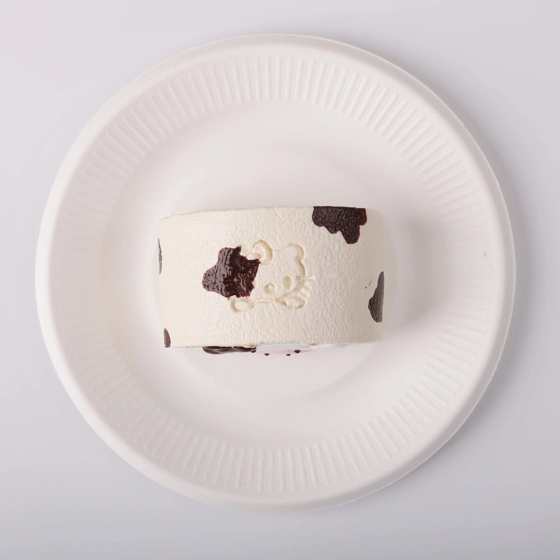 Creamy Tree Cow Swiss Roll Squishy Toy in a white plate