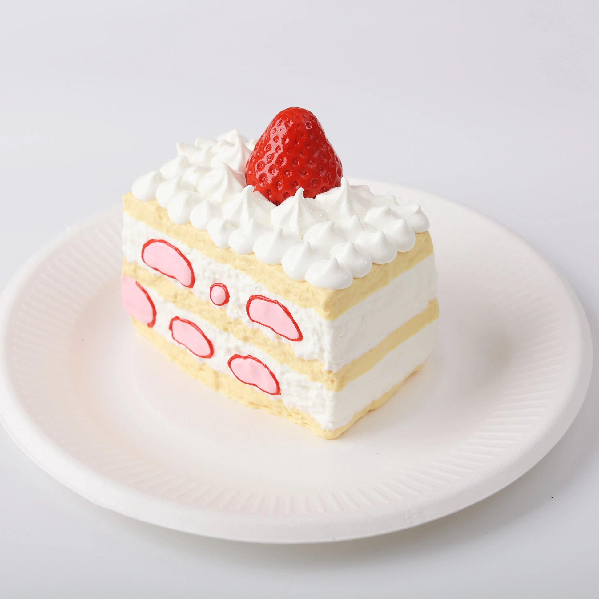 Side view of Creamy Tree Strawberry Filled Cake Squishy Toy