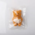 Front view of Creamy Tree teddy bear stress toy with white heart-patterned diaper in the plastic bag