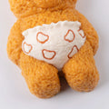 Close-up of orange Creamy Tree stress toy bear wearing a white diaper with heart shapes