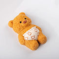 Side view of Creamy Tree teddy bear stress toy with white heart-patterned diaper