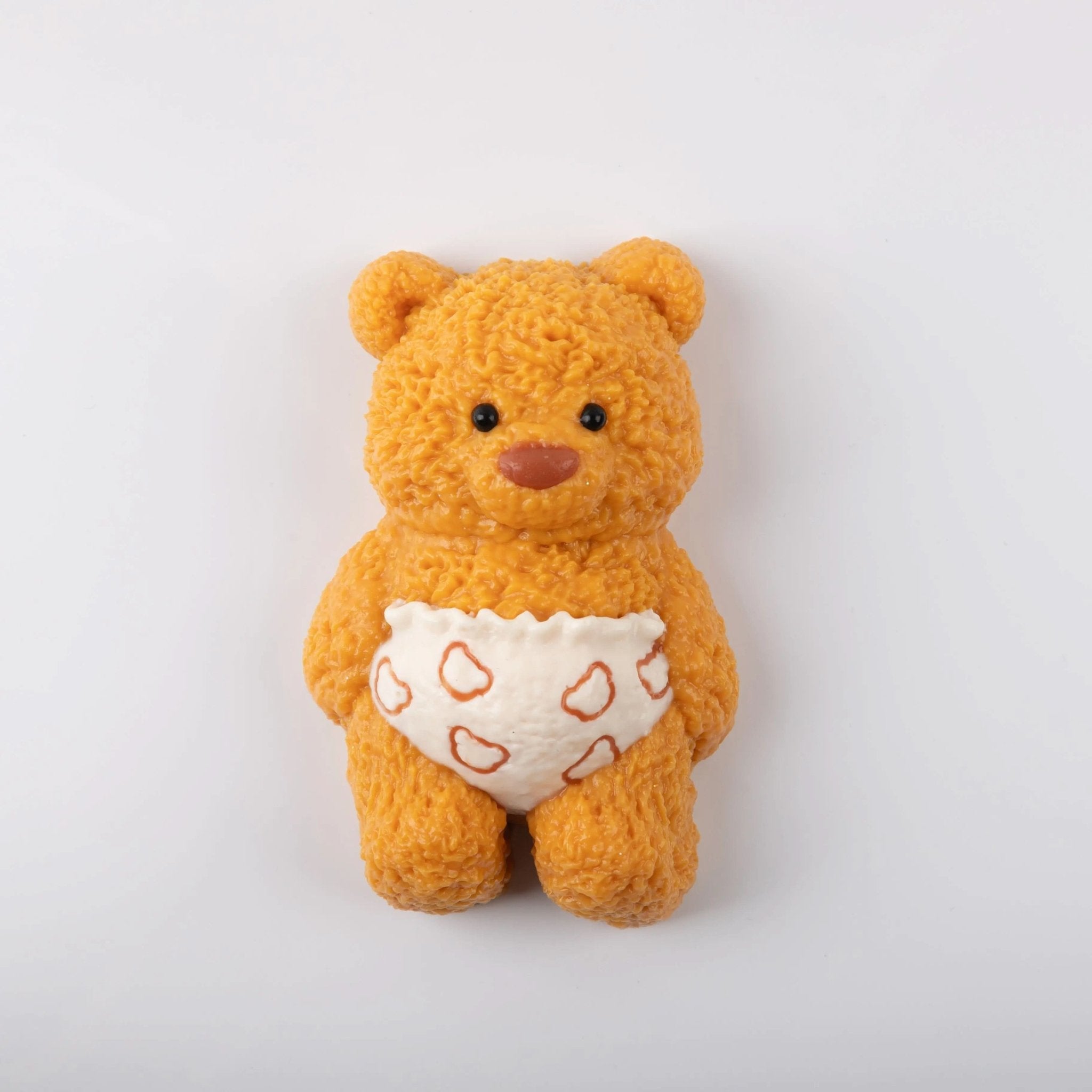 Front view of Creamy Tree teddy bear stress toy with white heart-patterned diaper