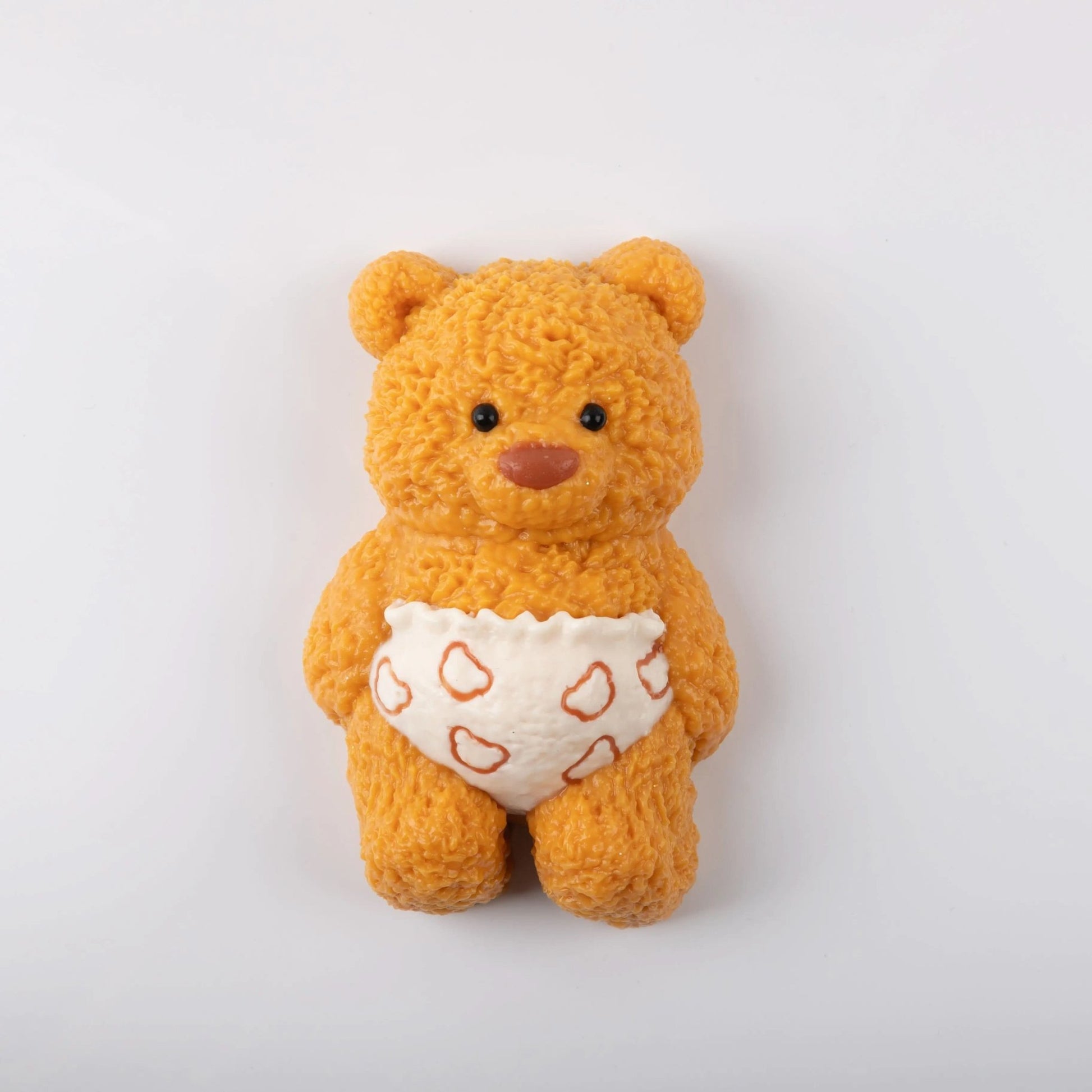 Front view of Creamy Tree teddy bear stress toy with white heart-patterned diaper