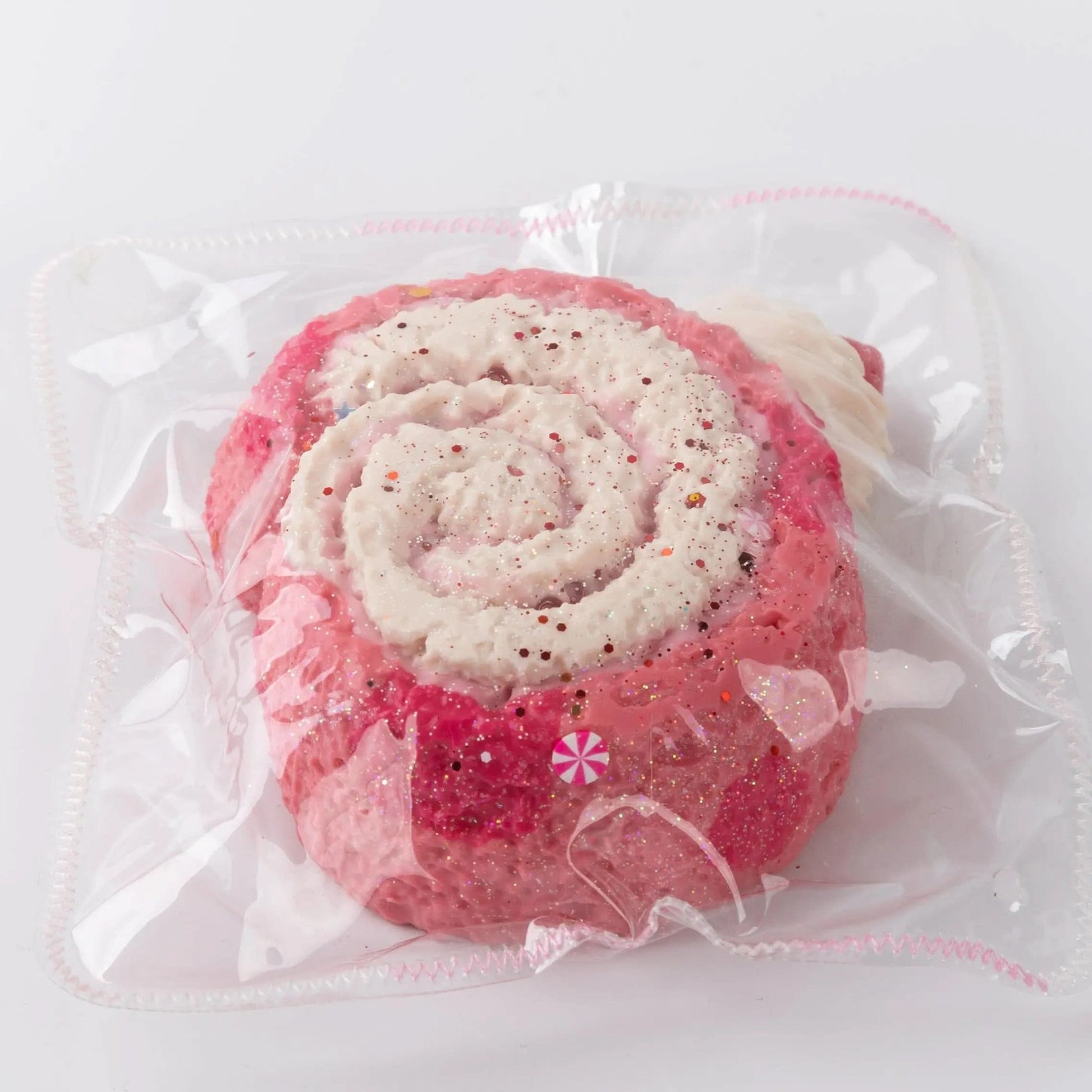 Close-up of Pink and White Creamy Tree Puff Swiss Roll Squishy toy with glittery things
