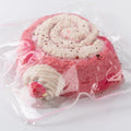 Close-up of Pink and White Creamy Tree Puff Swiss Roll Squishy toy with strawberry