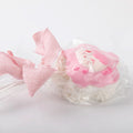 Detailed view of pink bow and textured layers on lollipop squishy toy