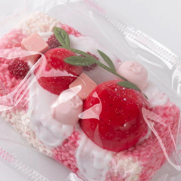Close-up from above of the Creamy Tree Pink and White Rice Ball squishy toy