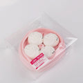 Side view of Creamy Tree Pink and White Dumplings Squishy toy with safety label