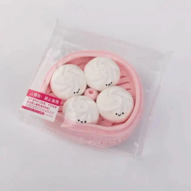 Side view of Creamy Tree Pink and White Dumplings Squishy toy with safety label